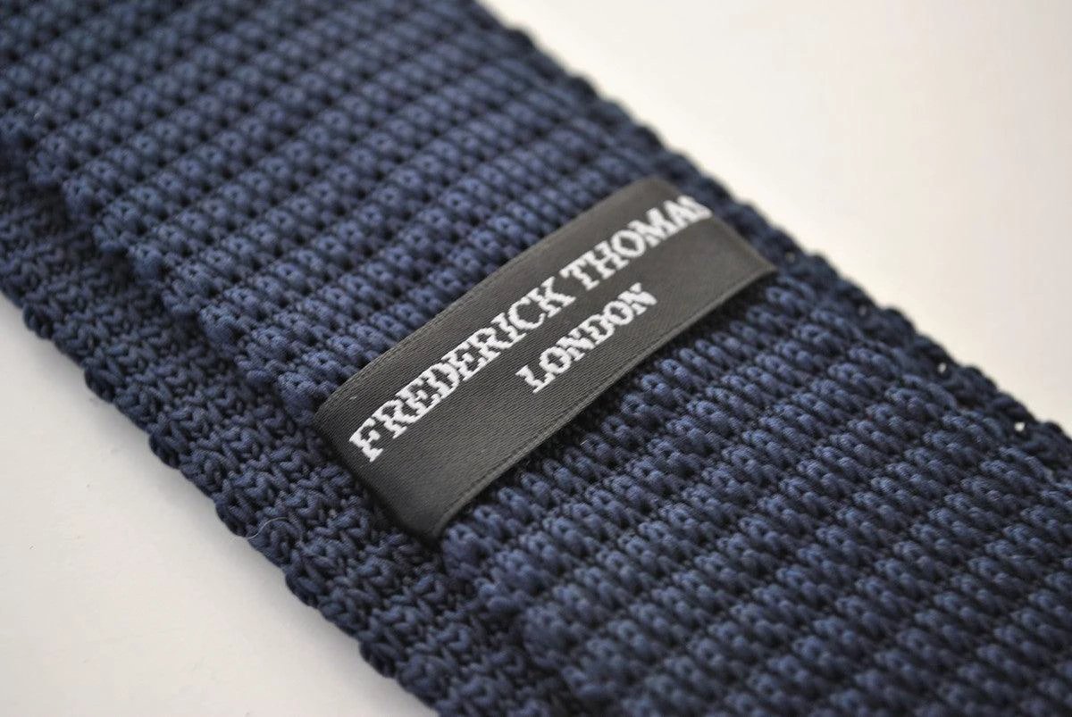 navy blue skinny knitted tie with gold polka dots by Frederick Thomas Handmade Mens Ties