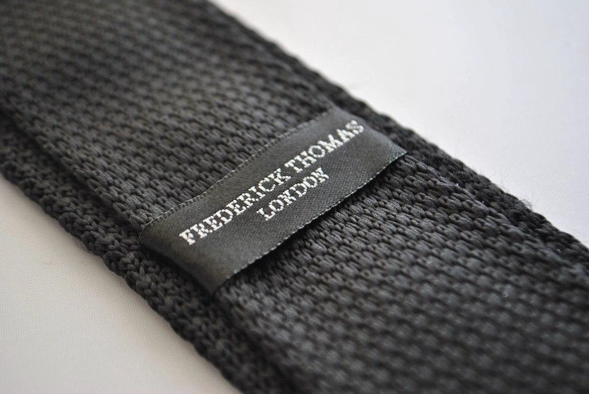 black skinny knitted tie with light blush pink polka dots by Frederick Thomas Handmade Mens Ties