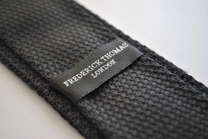 black skinny knitted tie with light blush pink polka dots by Frederick Thomas Handmade Mens Ties