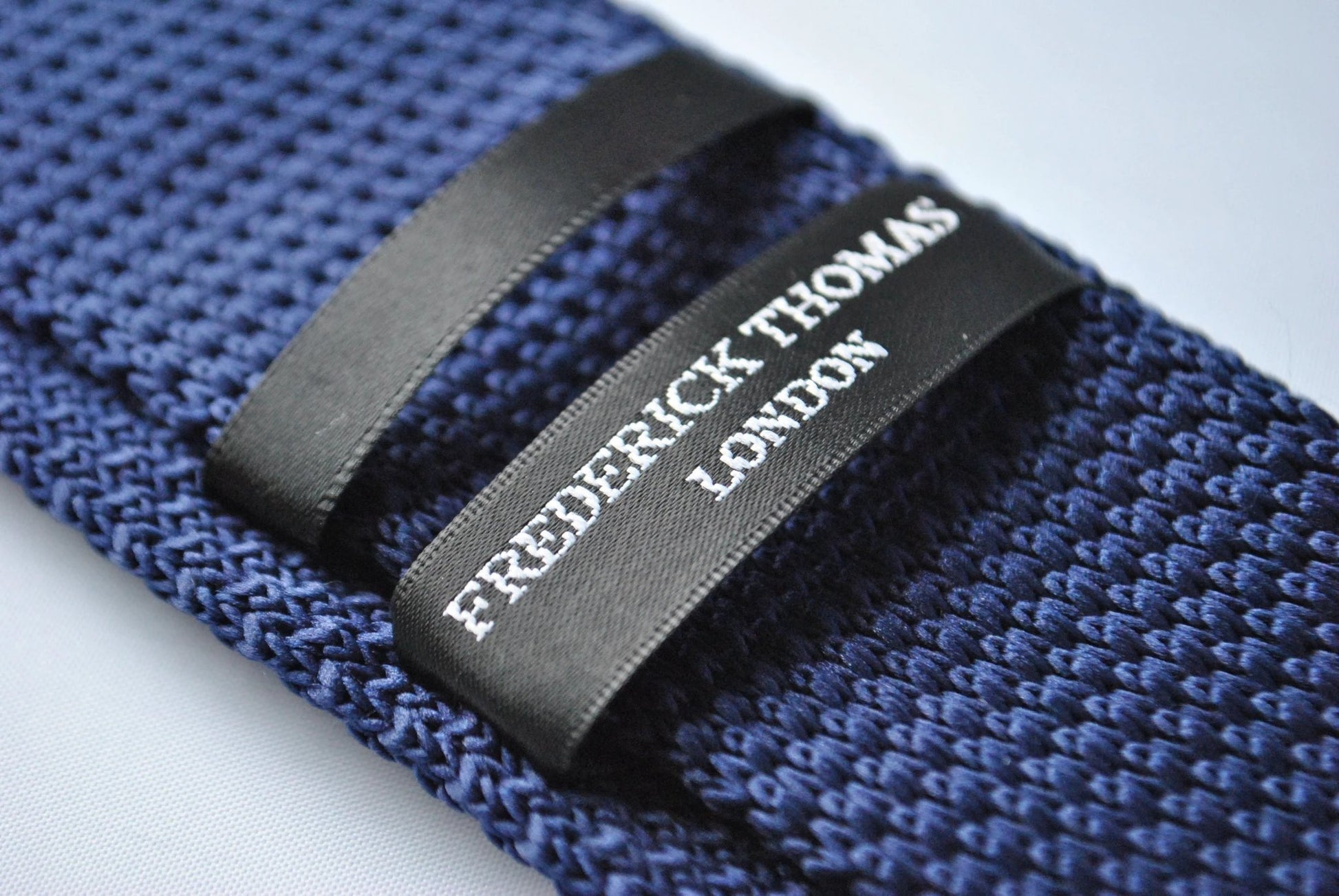 navy blue skinny knitted tie with light blue polka dots by Frederick Thomas Handmade Mens Ties
